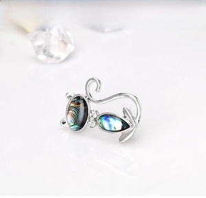 Detailed view of cat brooch with iridescent abalone shell inlay and crystal accents