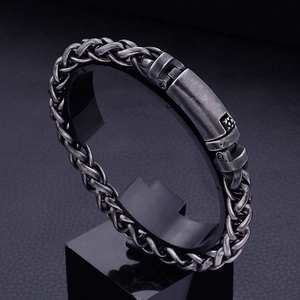 Vintage oxidized stainless steel braided chain bracelet with square clasp on display