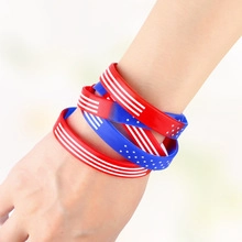 Close-up of stacked red white and blue silicone wristbands with US flag star pattern