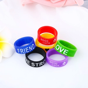 Close-up of colorful silicone rings with inspirational quotes and floral decorations