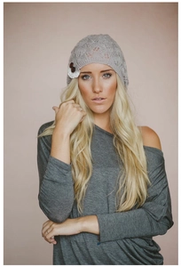 Professional model wearing an elegant grey knitted leaf pattern beanie with lace and buttons