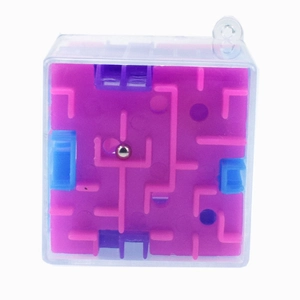 Macro detail of 3D cube maze puzzle with metal ball and colorful internal paths