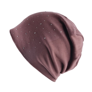 Close-up of knit fabric and silver rhinestones on the dark mauve slouchy beanie hat