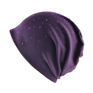 Detailed knit texture of dark purple slouchy beanie with sparkling rhinestone accents