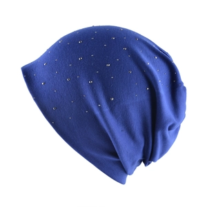 Detailed view of royal blue knitted slouchy beanie with sparkling silver rhinestones