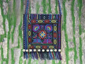 Detailed embroidery and colorful tassels on an ethnic style crossbody shoulder bag
