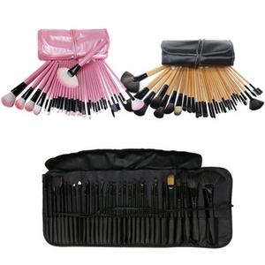 Three makeup brush sets in pink, wood, and black finishes with leather storage rolls