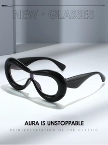 Macro detail of glossy black oversized frame with avant-garde curved streamline design