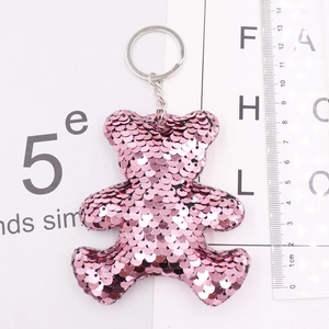 Close-up of pink sequined bear keychain with metallic ring and detailed shiny texture