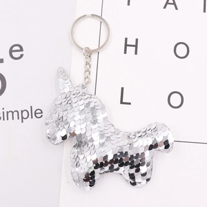 Detail of a silver sequin unicorn keychain with reflective surface and metal ring