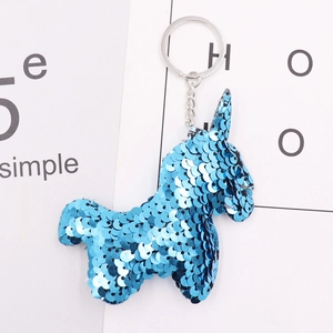 Detail of blue sequin donkey keychain showing reflective surface and silver metal ring