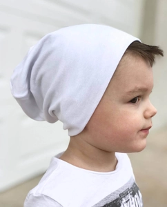 Close-up of a white cotton slouchy beanie for kids featuring soft ribbed texture and fit