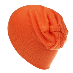 Detail of bright orange knit slouchy beanie for kids with fine stitching and soft texture