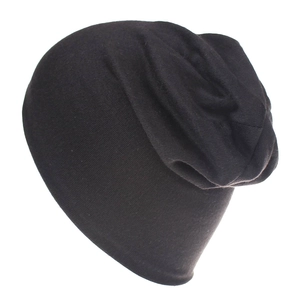 Close-up of the soft knitted texture and slouchy fold details of the black cotton beanie