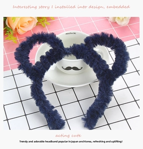 Detail of plush navy blue headband on a checkered surface with a decorative cup