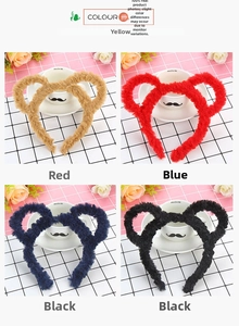 Close-up of plush bear ear headbands in yellow, red, blue, and black faux fur colors