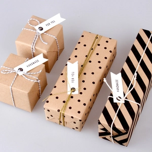 Minimalist handmade brown kraft paper gift tags on wrapped boxes with twine