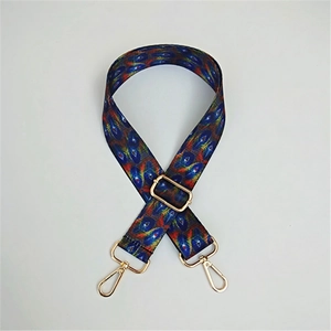 Close-up of adjustable ethnic style wide shoulder strap with colorful peacock patterns