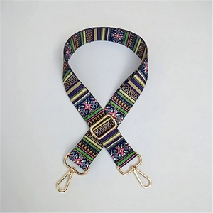 Close-up of adjustable ethnic style strap with colorful patterns and gold lobster clasps