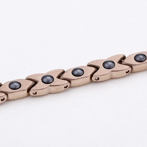 Rose gold magnetic therapy bracelet with X-shaped links and black hematite stones