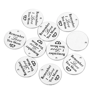 Macro view of polished silver stainless steel charms engraved with Remember I Love You Mom