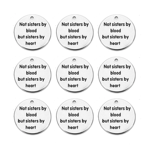 Detailed view of nine round stainless steel charms with sisters by heart engraving