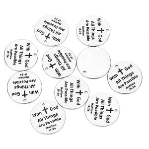 Macro shot of silver stainless steel round charms with Bible verse engraving for DIY jewelry
