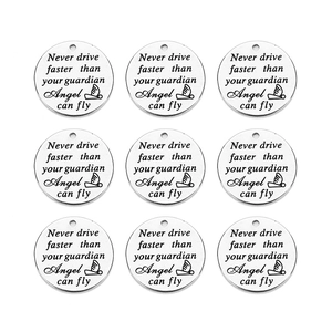 Macro shot of 9 silver round stainless steel pendants with guardian angel engraving