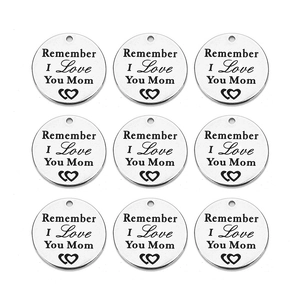 Macro shot of 9 stainless steel round charms engraved with Remember I Love You Mom