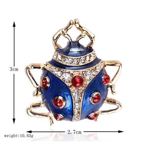 Detailed view of enamel ladybug brooch with blue wings and dimensions 3cm x 2.7cm