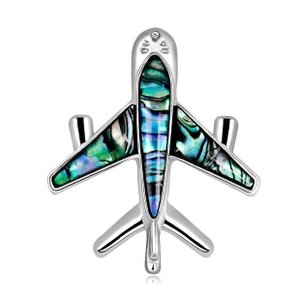 Detailed view of silver aircraft brooch featuring colorful abalone shell wing inlay