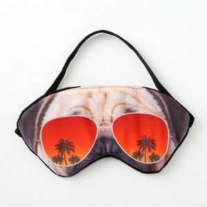 Close-up of 3D pug sleep mask featuring pilot sunglasses with a sunset beach print