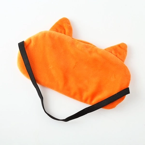 Close-up of orange 3D animal plush sleep mask with fuzzy texture and black elastic strap