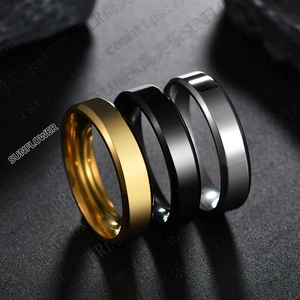 Polished stainless steel rings in gold, black, and silver showing beveled edge design