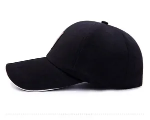 Close-up of a black baseball cap featuring a vintage leather patch and structured brim