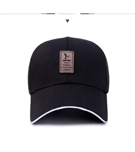 Close-up of black baseball cap featuring a brown leather patch and white edge stitching