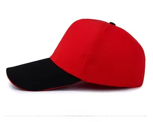 Side view of a cotton canvas baseball cap with red crown and black peak