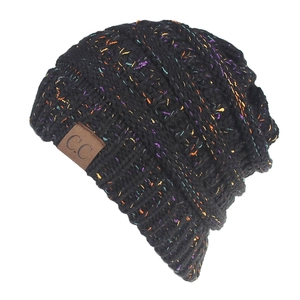Detailed close-up of thick black knit beanie with multicolored flecks and leather logo patch