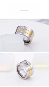 Detail of wide two-tone titanium steel rings with square stones and micro-pave setting