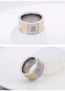 Detailed close-up of wide two-tone titanium ring with square center stone and micro-inlay