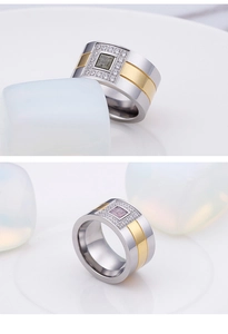 Macro shot of two-tone wide band titanium rings with green and purple gemstones