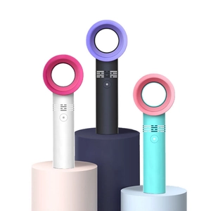 Portable bladeless handheld fans in three colors on display stands with USB charging