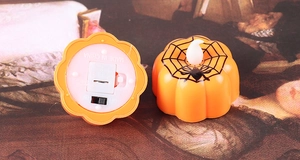 Detail of Halloween pumpkin LED candles with battery compartment and power switch