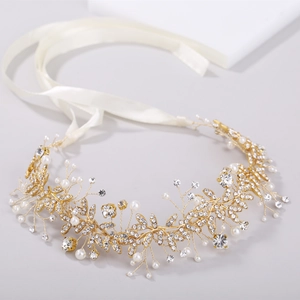 Elegant bridal gold headband with faux pearls and crystals on a minimalist background