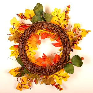 Autumn thanksgiving wreath with vibrant maple leaves and berries on a natural vine base