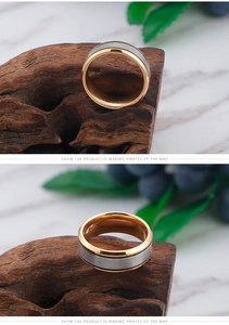 Detail of titanium steel ring with gold edges and silver brushed metal finish center