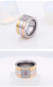 Detailed view of tri-color wide titanium ring with a square pink center stone and halo