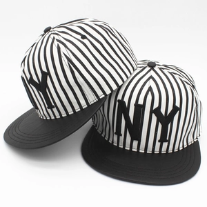 Detail of striped hip-hop baseball cap with NY embroidery and flat black brim