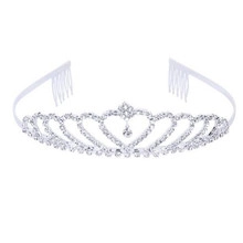 Close-up of silver rhinestone crown with central heart motif and side hair combs