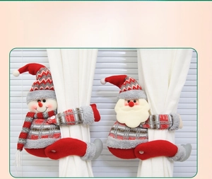 Detailed view of handmade Santa and Snowman curtain tiebacks on white curtains